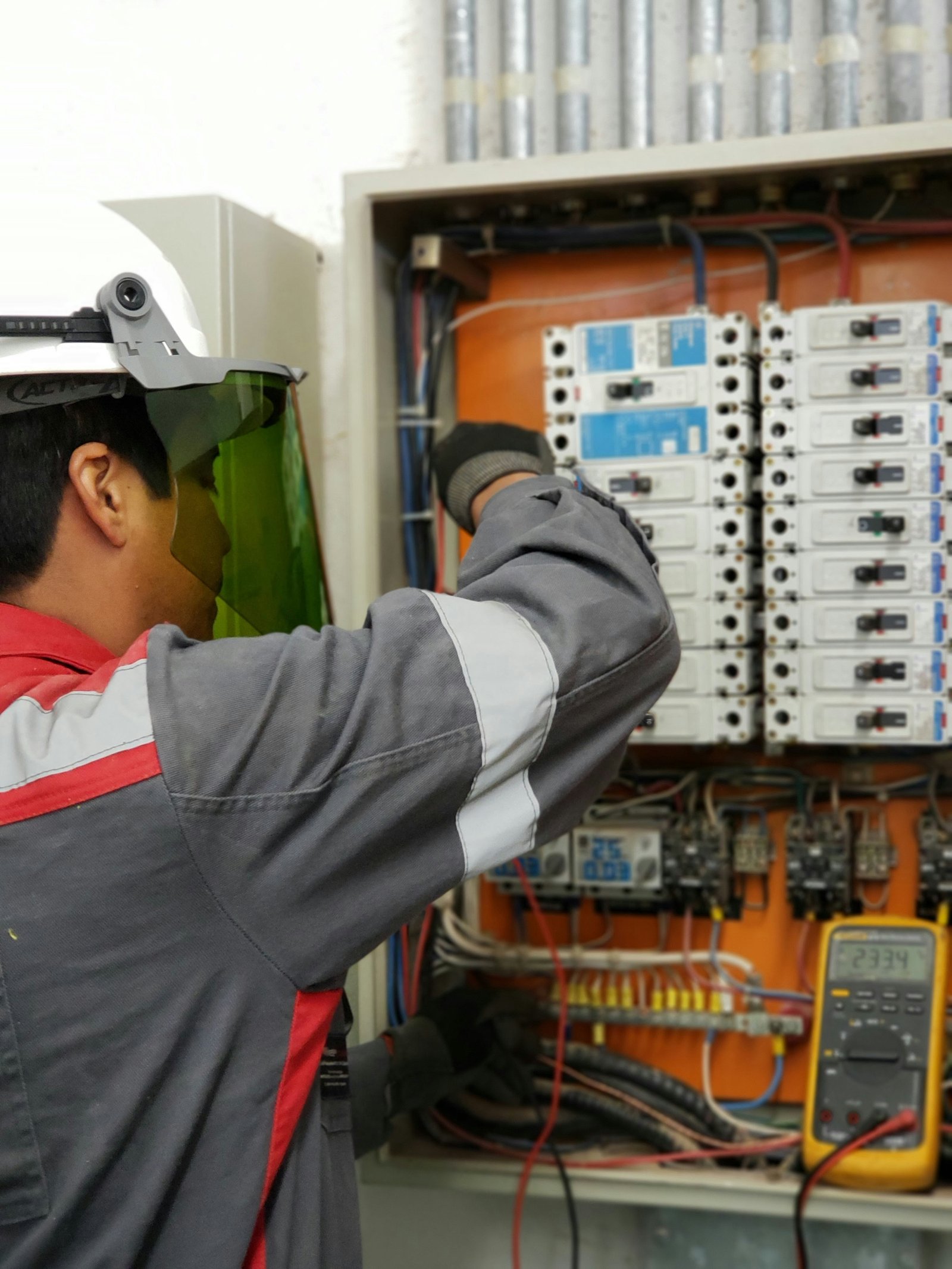 Amerta Energy technician working on an electrical panel